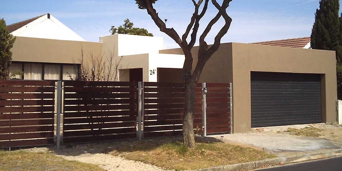 Charcoal horizontal slatted aluzinc sectional door and meranti fencing