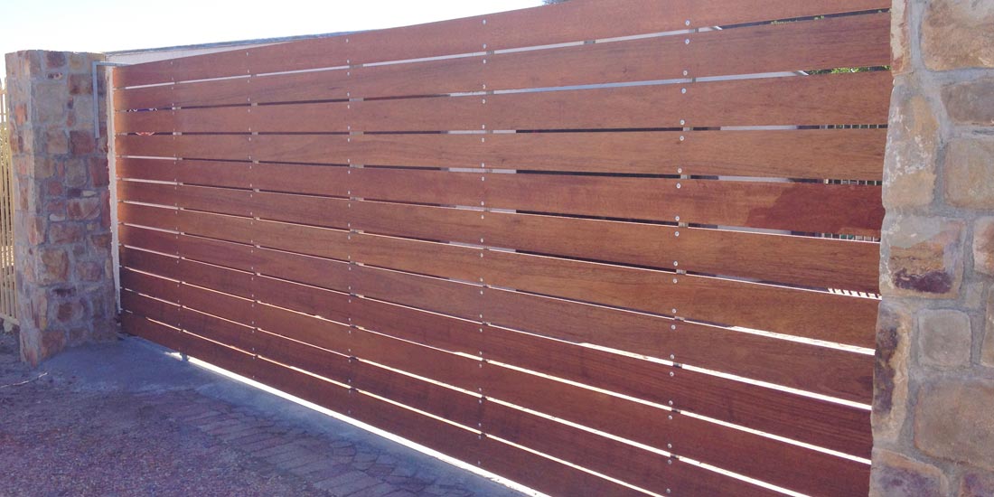 Horizontal slatted meranti sliding gate with 20mm gaps & rivets