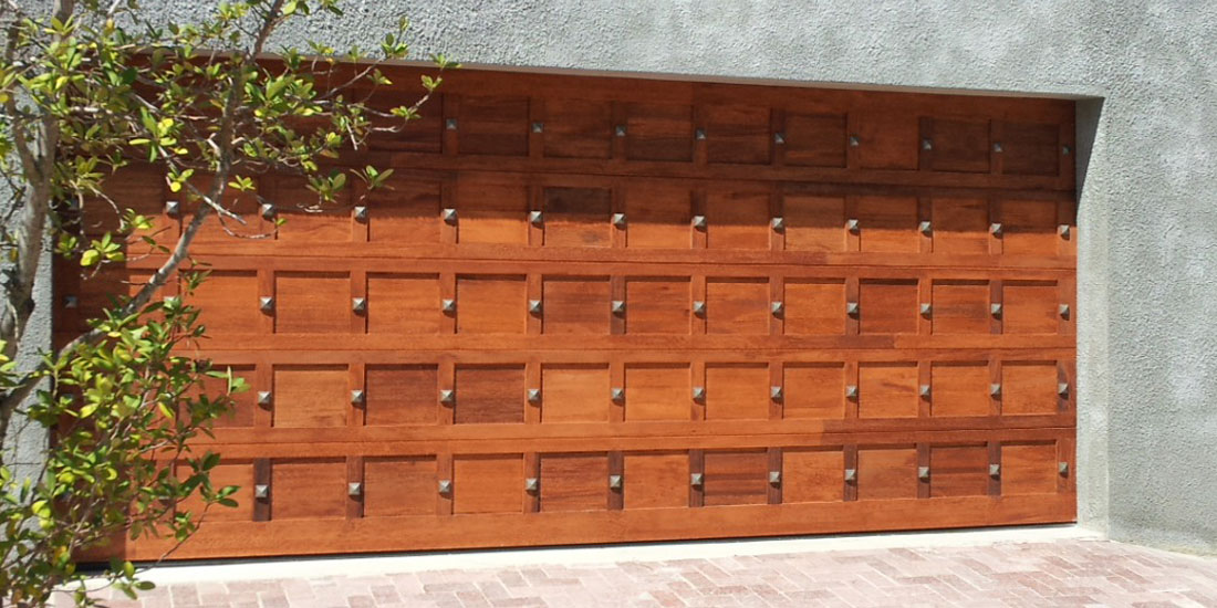 Double meranti sectional studded door - golden brown oil